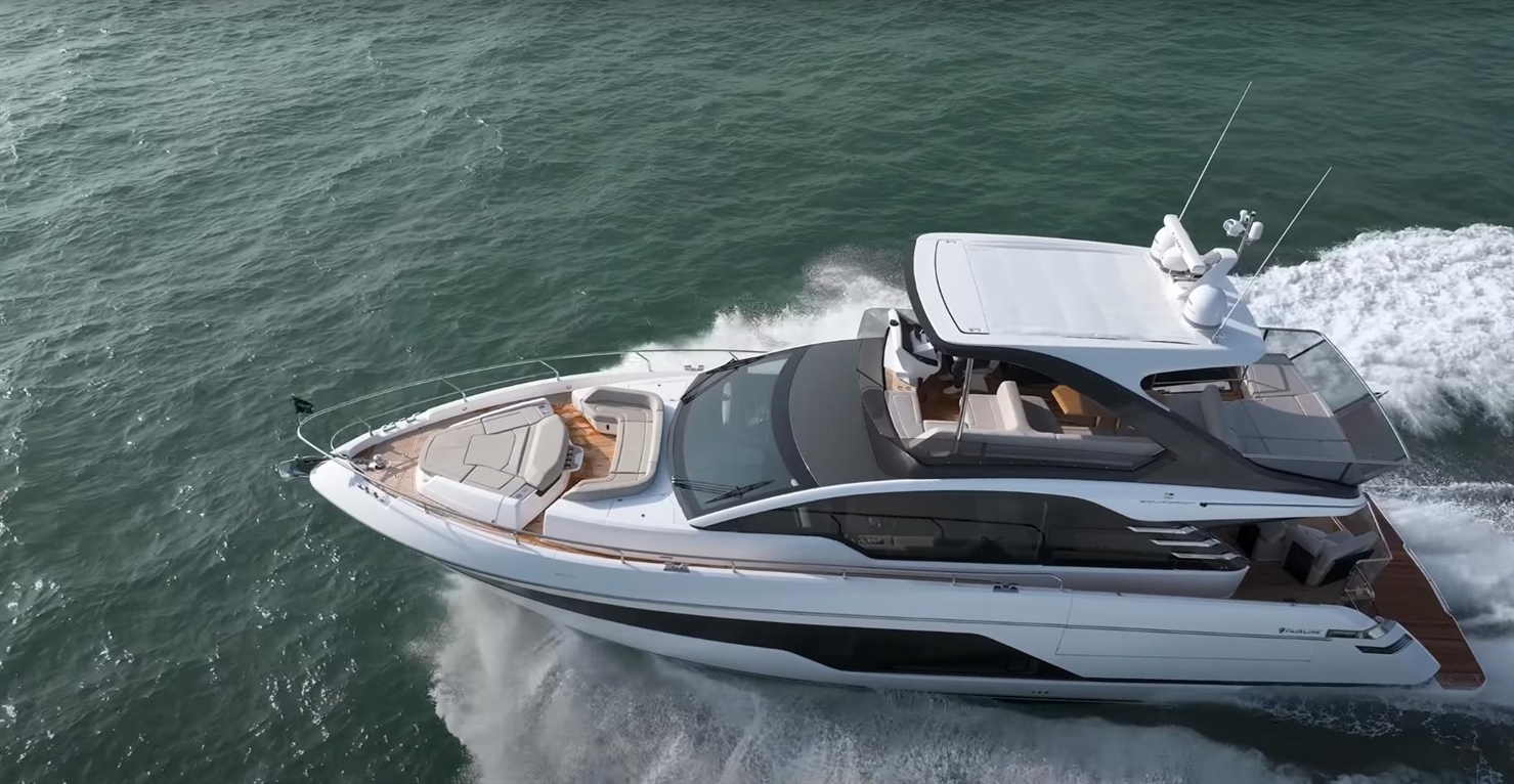 Luxury motor yacht cruising through the water, showcasing a sleek design and spacious deck for relaxation.